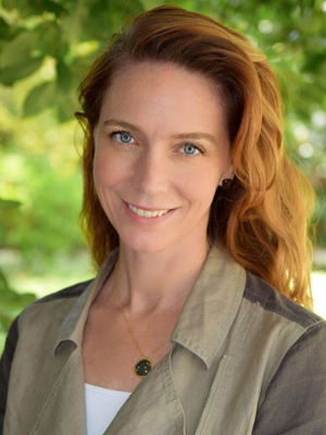 Photo of Kim Cobb outside with greenery and leaves in the background