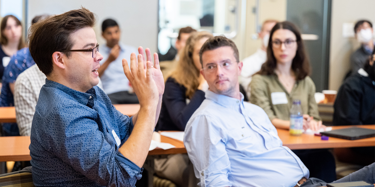 Groos Family Assistant Professor of Economics Peter Hull (left), one of the event organizers, speaks during a discussion at the Bravo Center Workshop on the Economics of Algorithms.