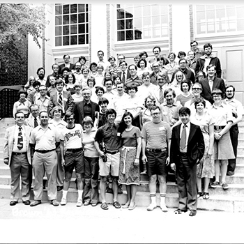 Black and white group photo of the Class of 1963 standing on steps outside of a building