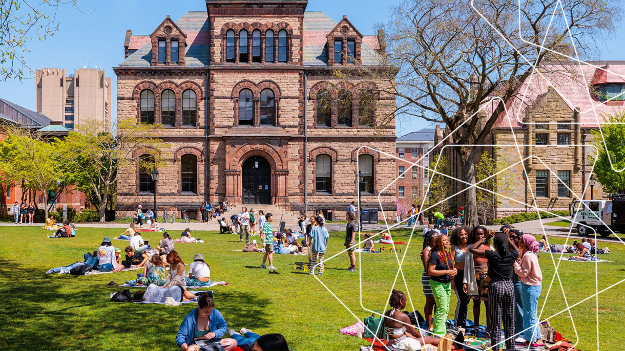 Campus during the spring with students gathered on the green at Brown.