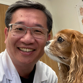 Photo of Steve Shin with a dog.