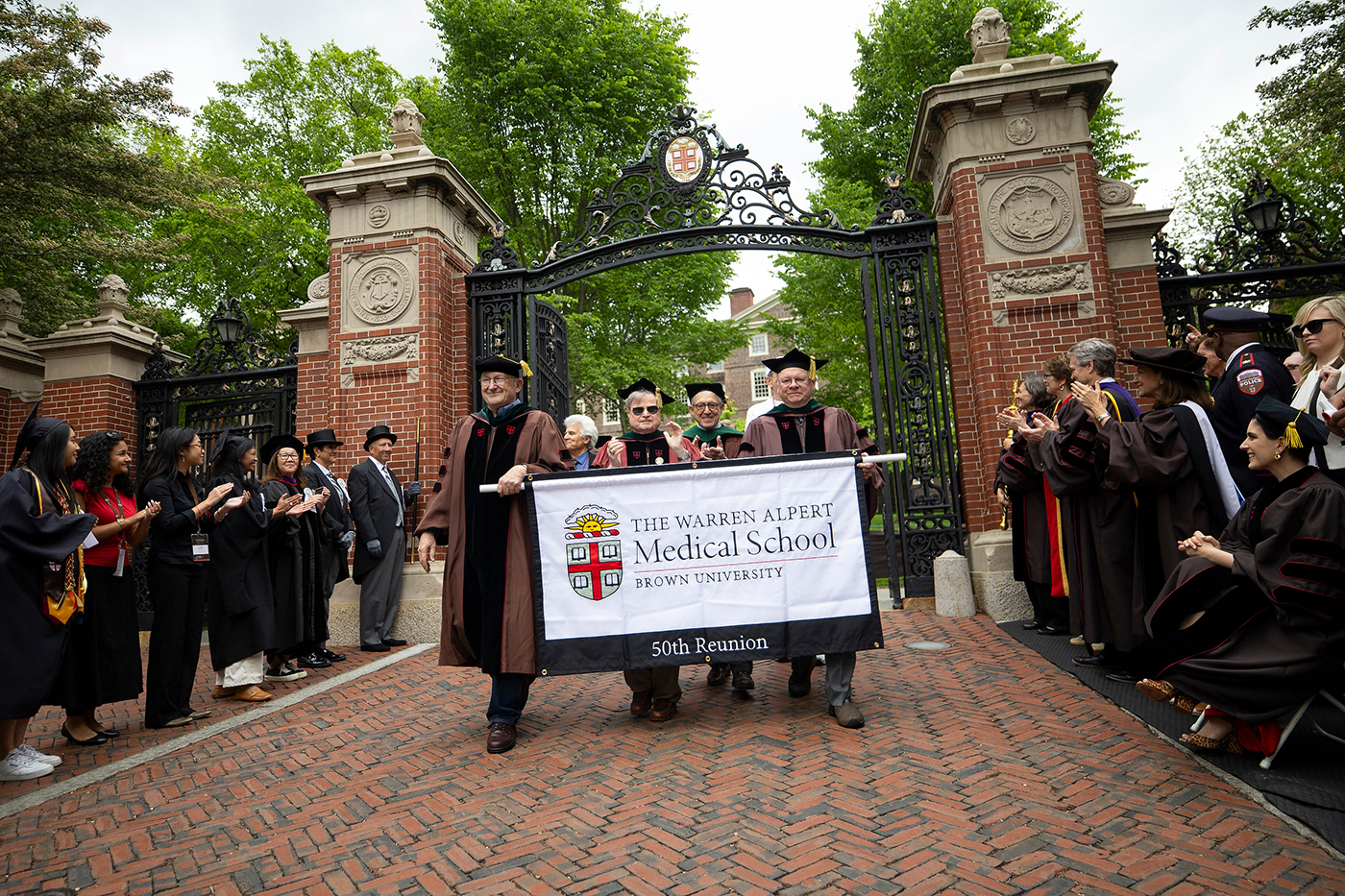 Medical alumni process through the Van Wickle Gates during Reunion.