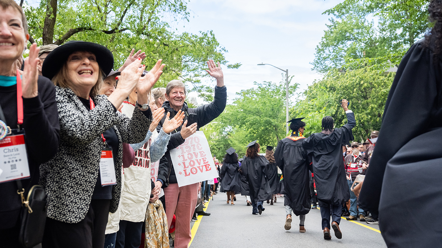 Alums cheering on graduates during Procession 2025