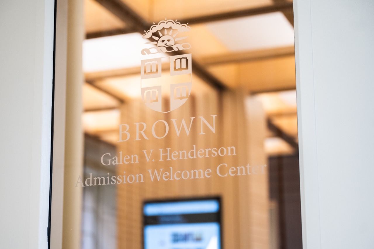 Etching in glass with the Brown crest that reads Galen V. Henderson Admission Welcome Center.