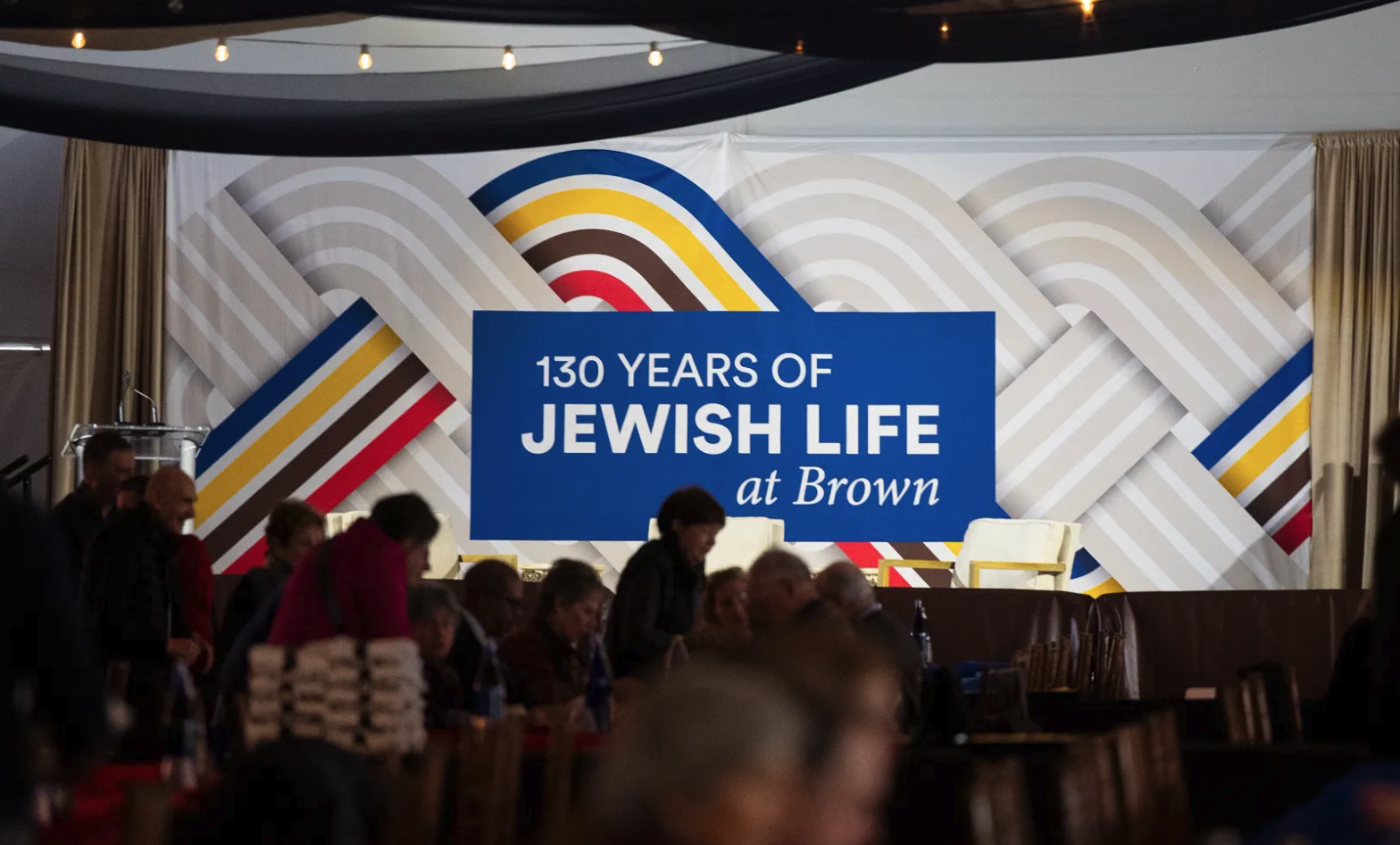 An banner reading 130 Years of Jewish Life at Brown is lit up during the November event on campus.