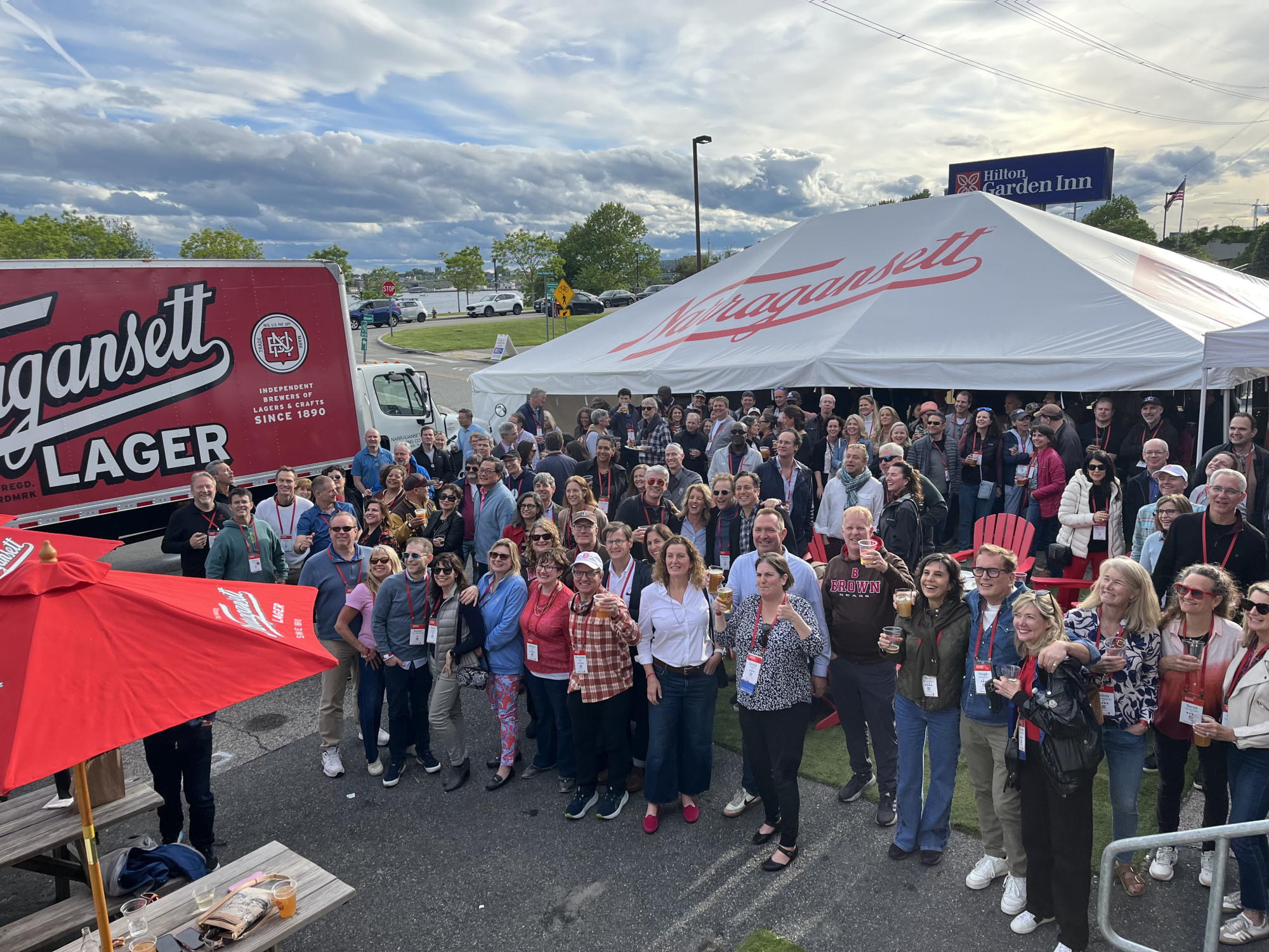 The Class of 1990 standing in front of a tent at a class event.