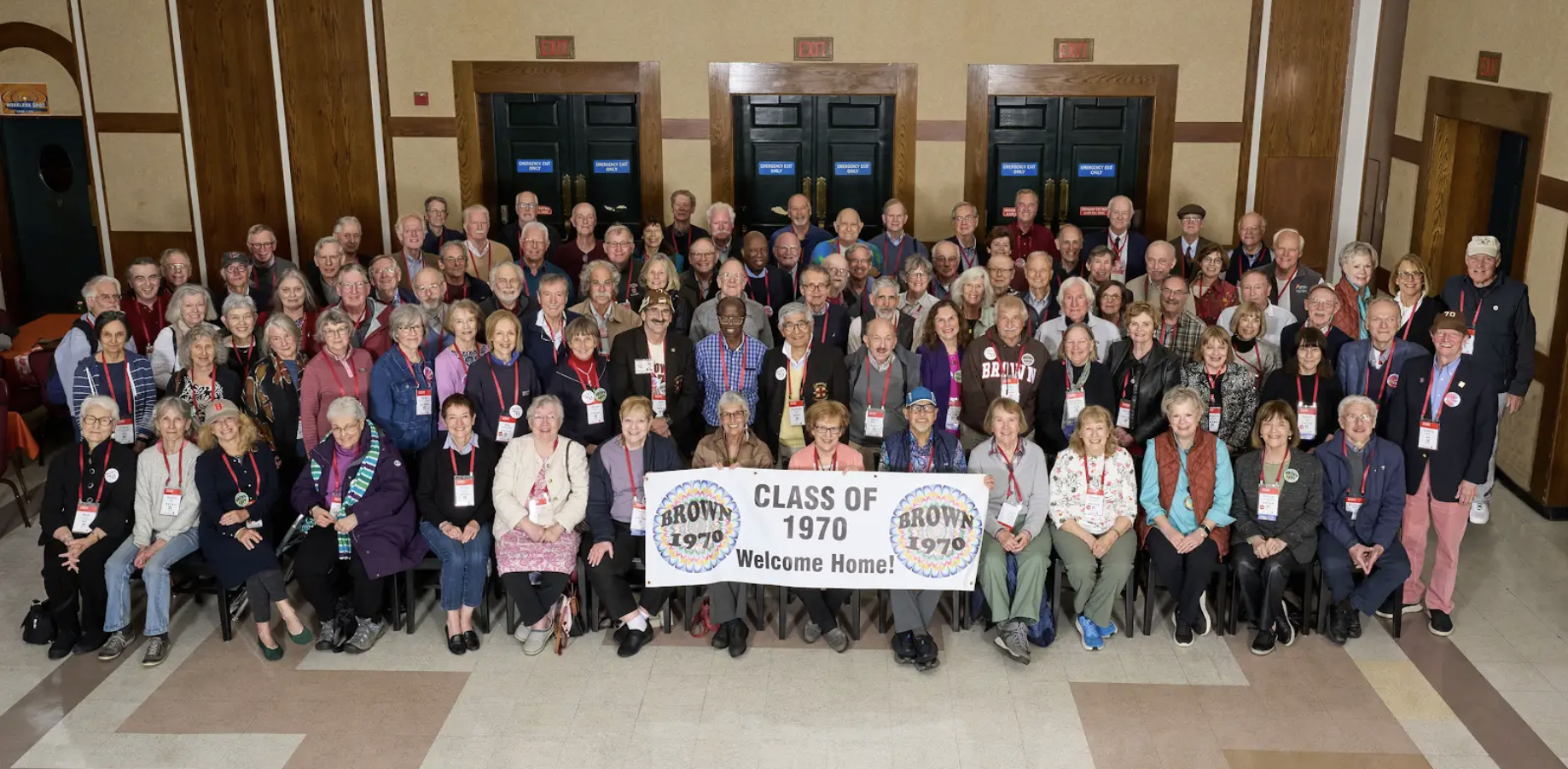 The Class of 1970 seated and posing for a group photo with a class banner.