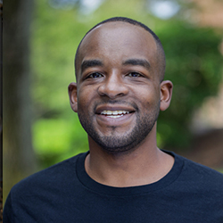 Max Clermont smiling and wearing a black shirt.