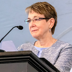 Patricia Buss speaking at a podium at a Brown event