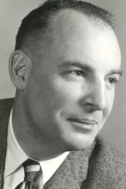 A black and white portrait of John McLaughry.