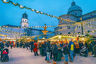 People gathered at a Christmas market outdoors.