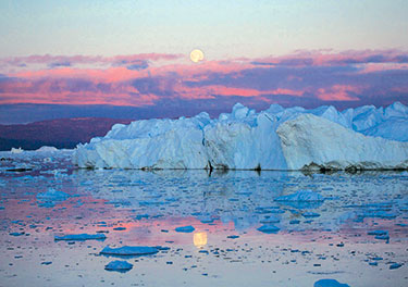 Moon over iceberg with a pink sky.