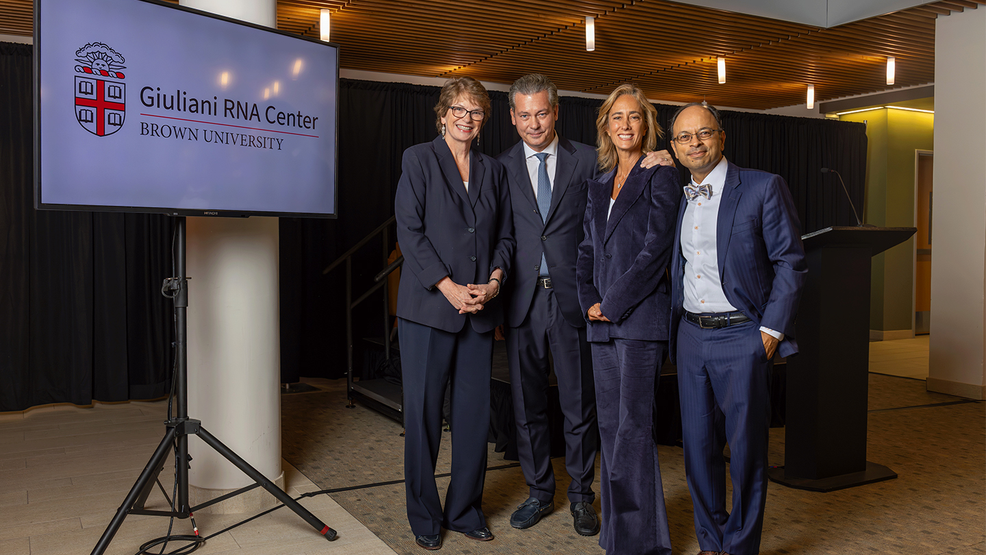 Brown President Christina H. Paxson (left) shared news of the gift and naming during an RNA symposium at Brown. Pictured with Paxson are Giammaria Giuliani, Sabrina Giuliani and Warren Alpert Medical School Dean Mukesh Jain. Photo by Mike Cohea.