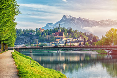 lake with town and mountain in background