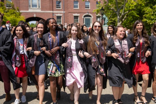 Group of students in graduation gowns walking together