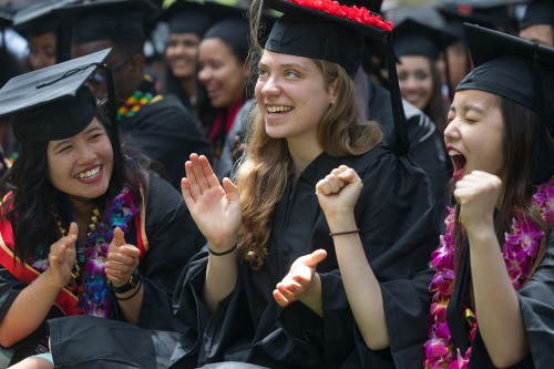 Three female graduations celebrating at Commencement.