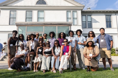 Attendees of the Bruno on the Vineyard event posing in front of a building on Martha's Vineyard.