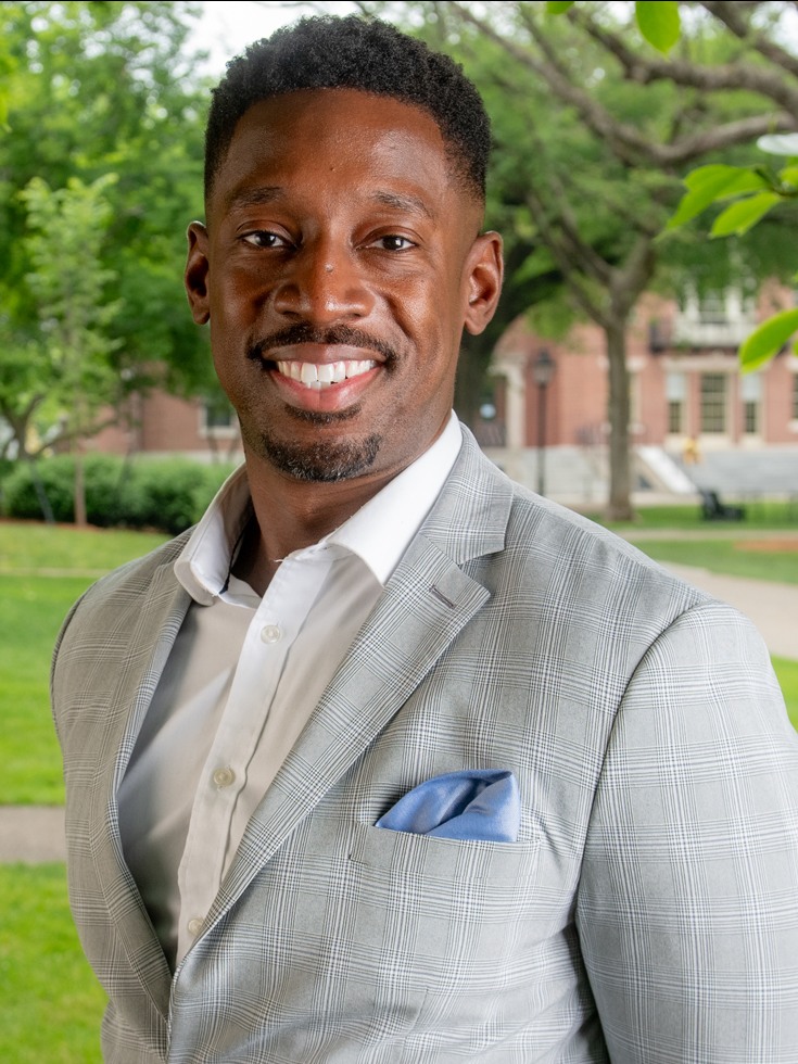 Sean Thompson, assistant dean of the college and director of student exploration, posing for a photo on Brown's campus.