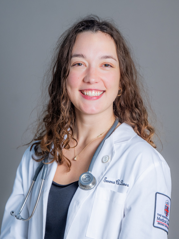 Emma Danes poses for a photo in her white coat.