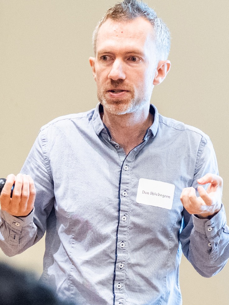 Professor Daniel Björkegren gesturing during a workshop discussion.