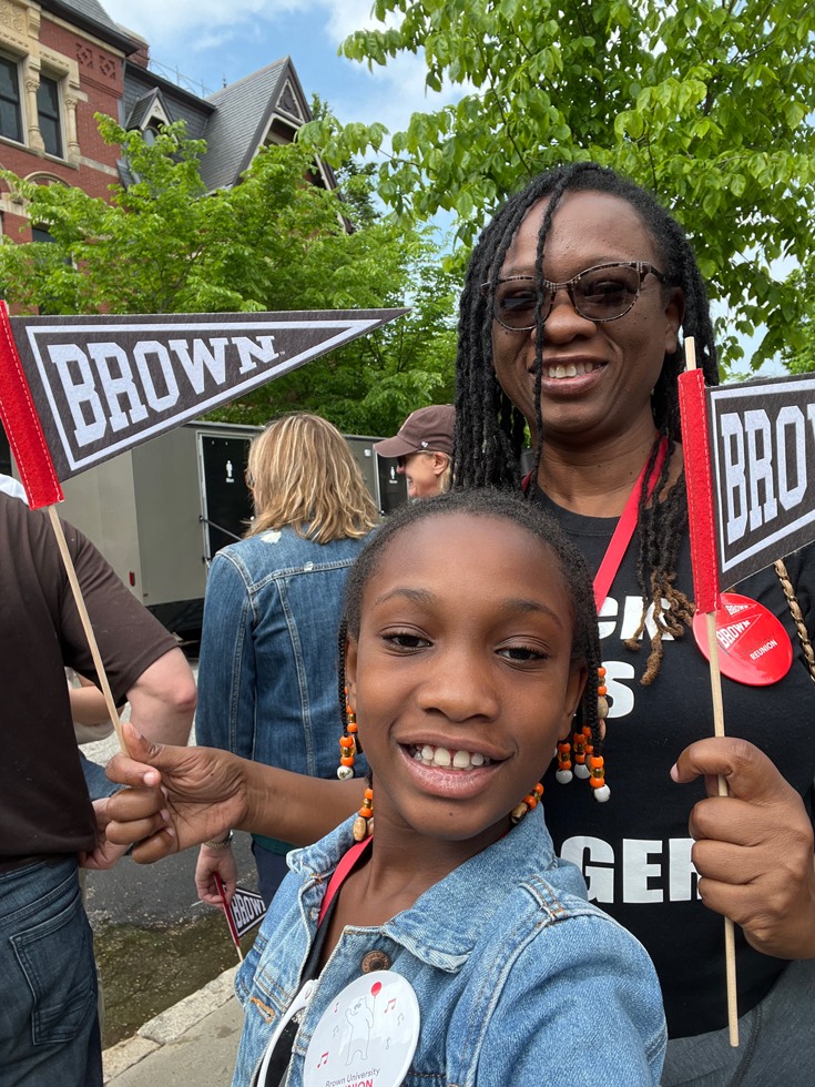 Glenda C. Wrensford ’94 with her daughter holding Brown pennants during Reunion celebrations.