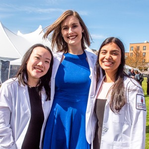Three students in their white coats