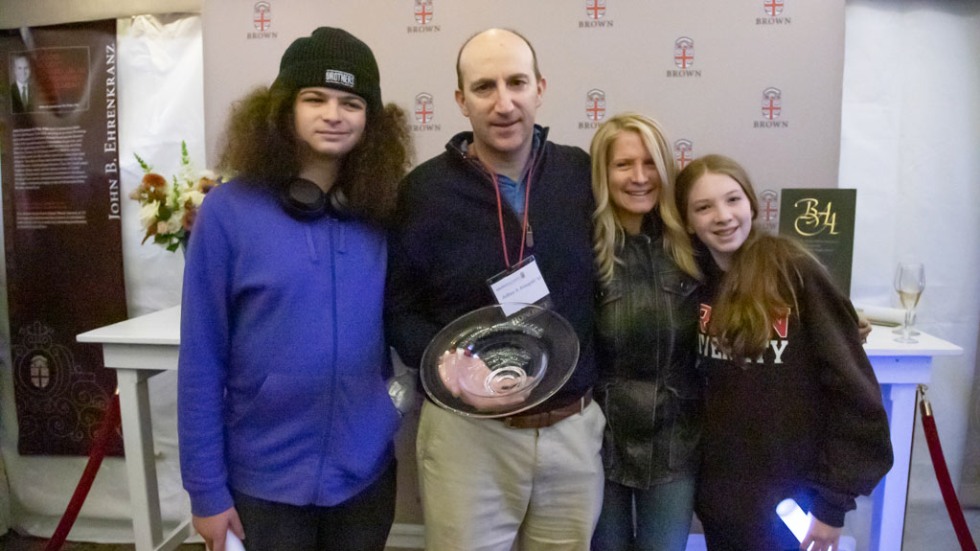 Jeffrey S. Feingold ’92 holding his award with his family 