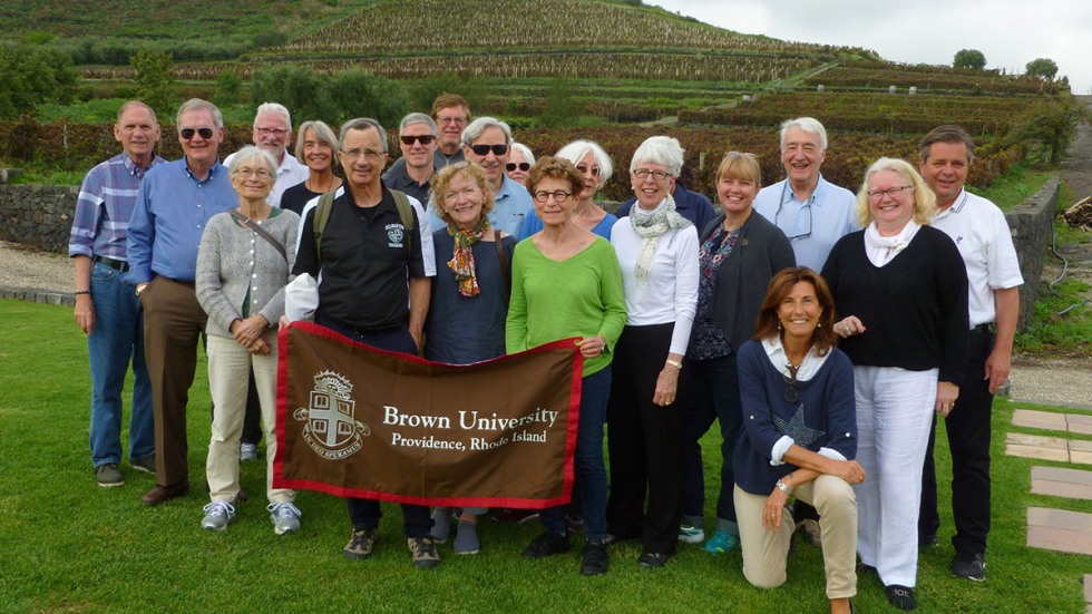 Alumni posing with Brown University banner at a winery