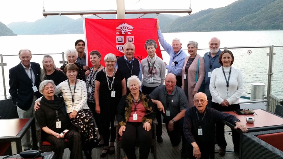 Alumni posing in front of Brown University flag on the Danube