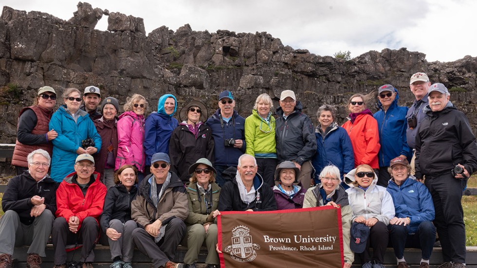 Alumni posing with Brown University banner in Iceland