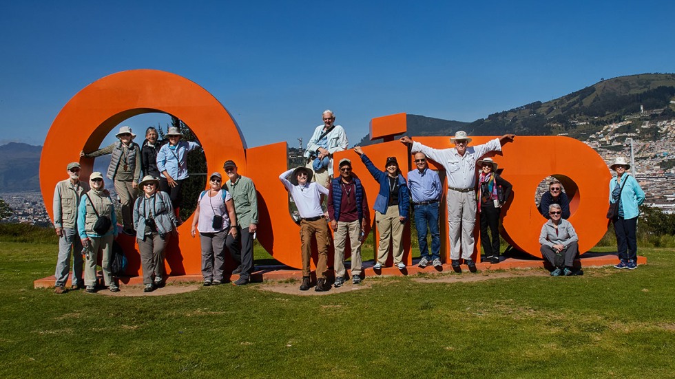 Alumni at the Quito sign