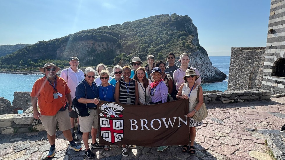 Alumni posing with Brown University banner at Porto Venere