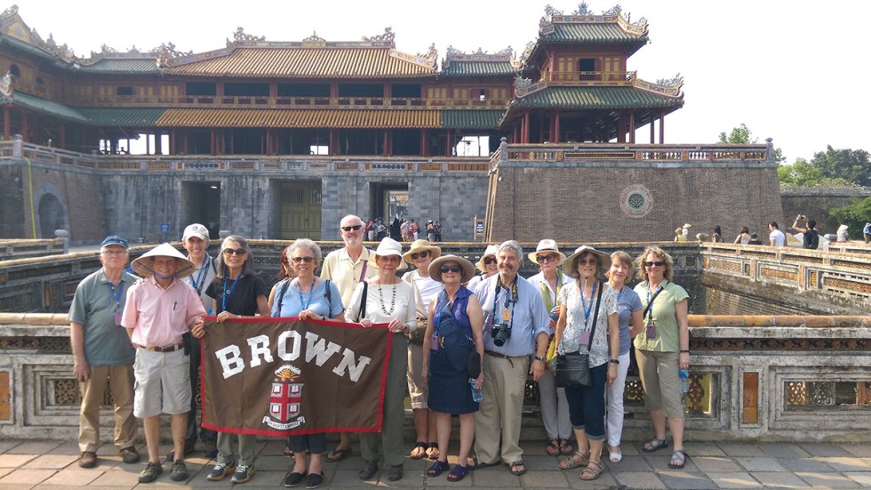 Alumni posing with Brown University banner in Vietnam
