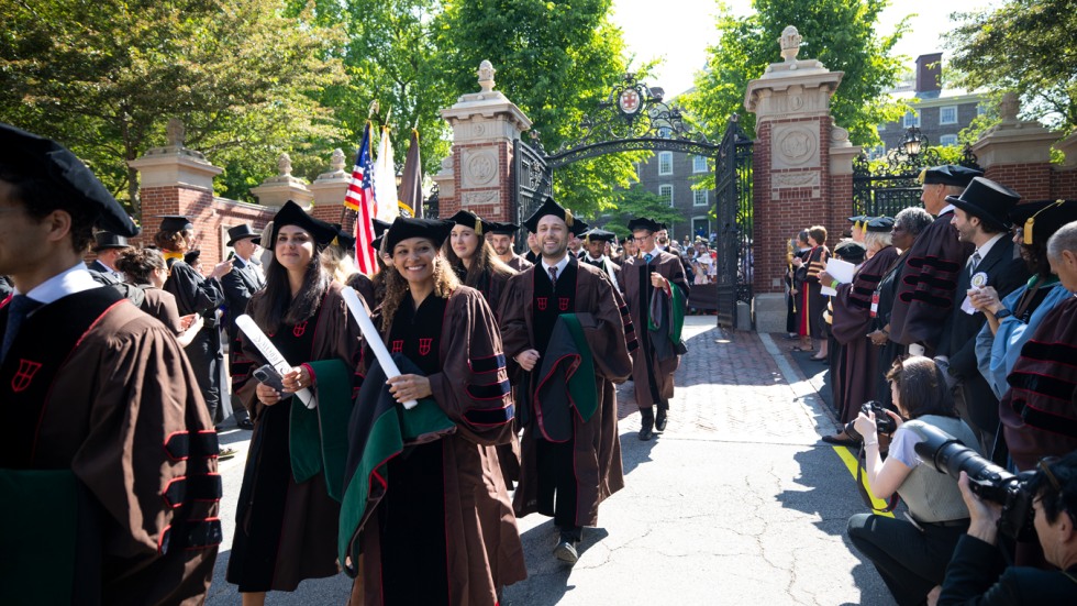 Members of the Medical School's Class of 2023 march through the Van Wickle Gates