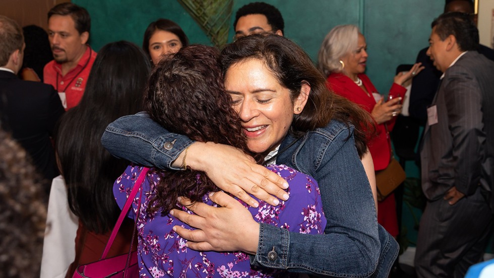Jennifer Yerex Welch ’92 (in purple) and Graciela Gerace Cerda ’93, P’23 embrace during the reception. 