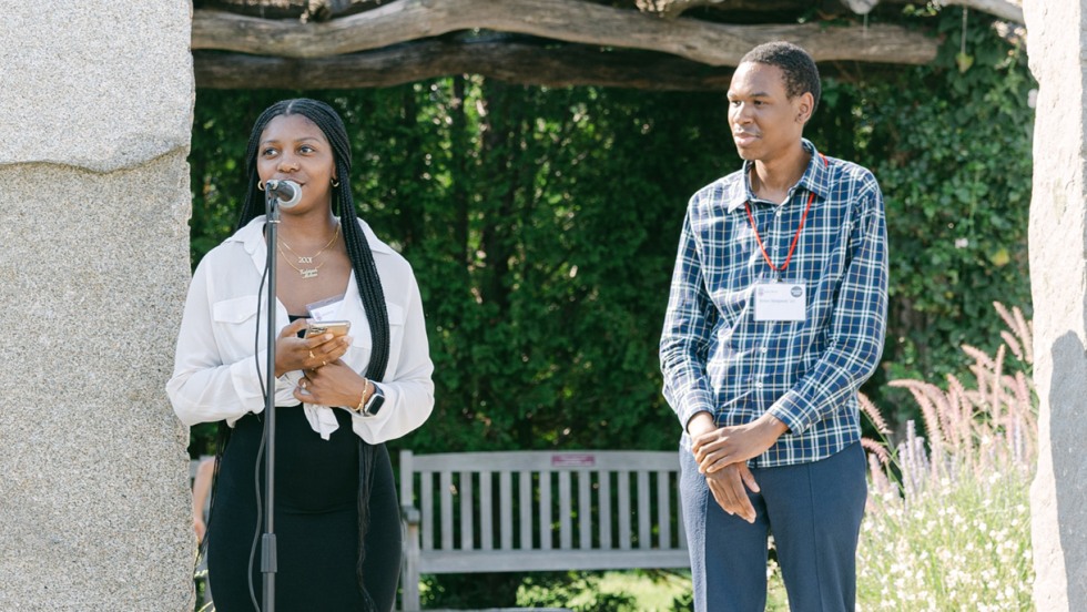 Zakiyah Whitaker '23 (left) and Peter Simpson '20 (right) speaking at the Martha's Vineyard event outdoors.
