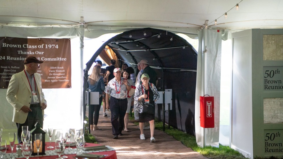 couple exiting the 50th Reunion tent with lights