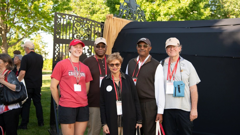 alums posing with current Brown student