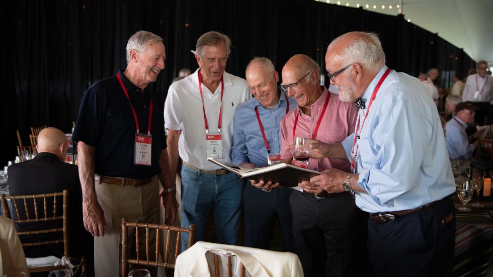 alums looking at a yearbook together