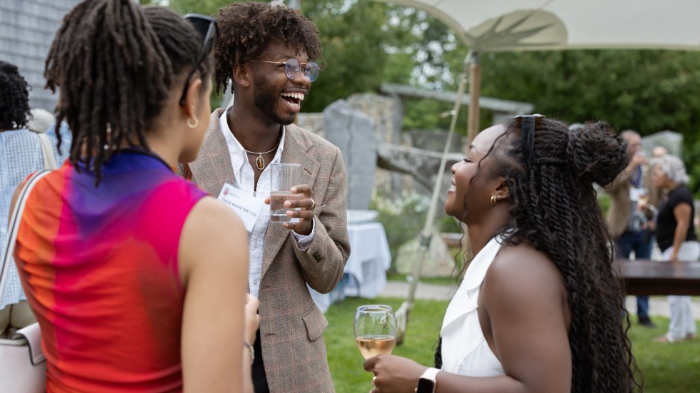 Three guests at the Bruno on the Vineyard event laughing together.