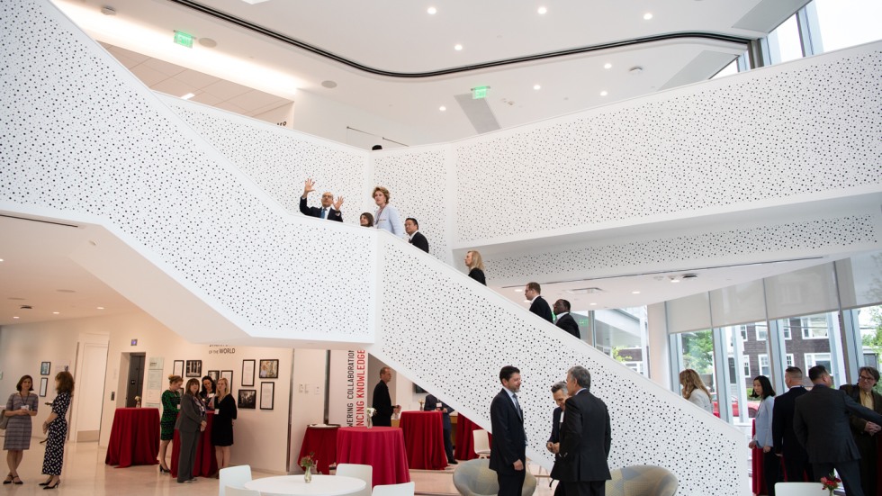 Inside the Stephen Robert ’62 Hall, a view of the agora with people socializing during an event.