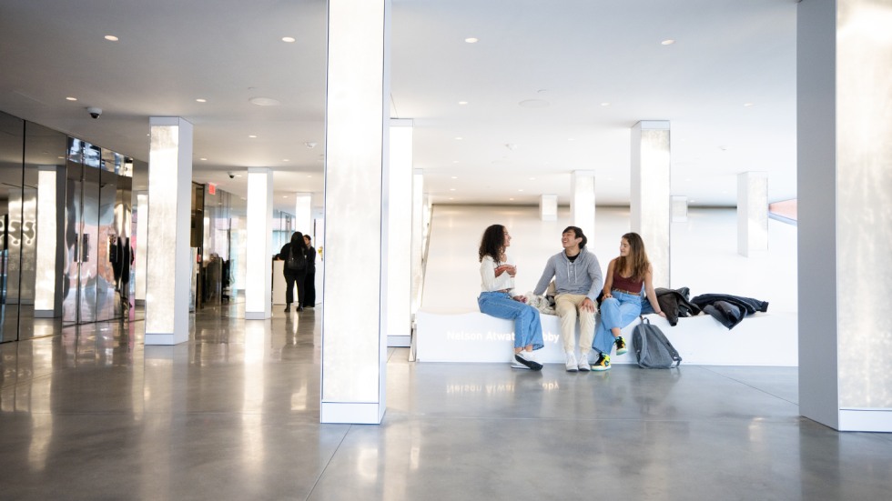Students sit in the sun-filled lobby of The Lindemann.