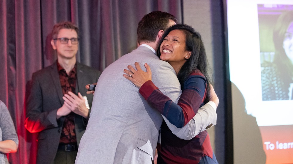 Vice President for Alumni Relations Zack Langway ’09 congratulating an alumni award recipient during a special recognition ceremony. 