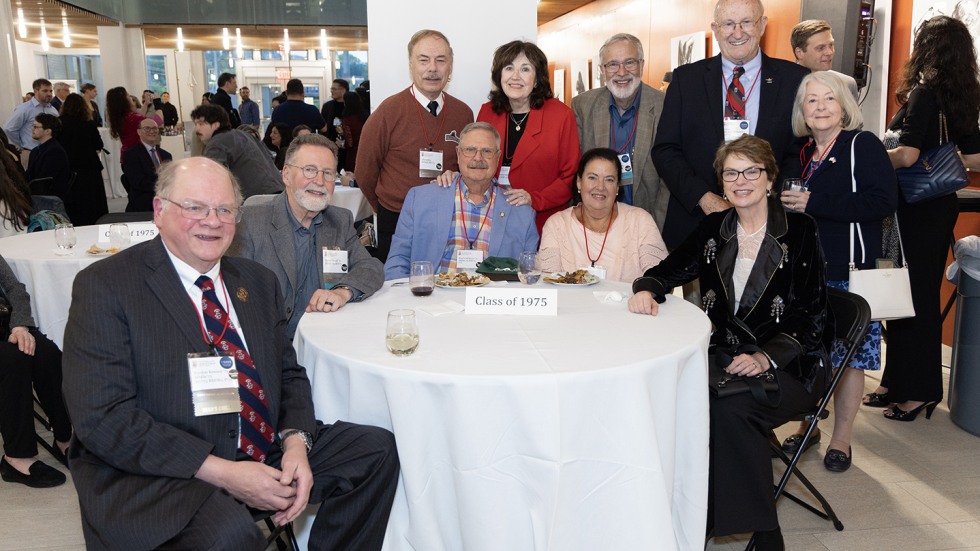 President Christina H. Paxson at a table with members of the class of 1975