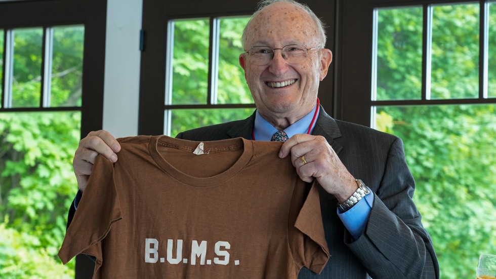 Glenn W. Mitchell holding B.U.M.S. t-shirt