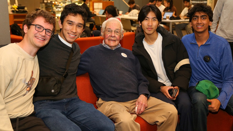 Hazeltine sits with a group of undergraduate students. 