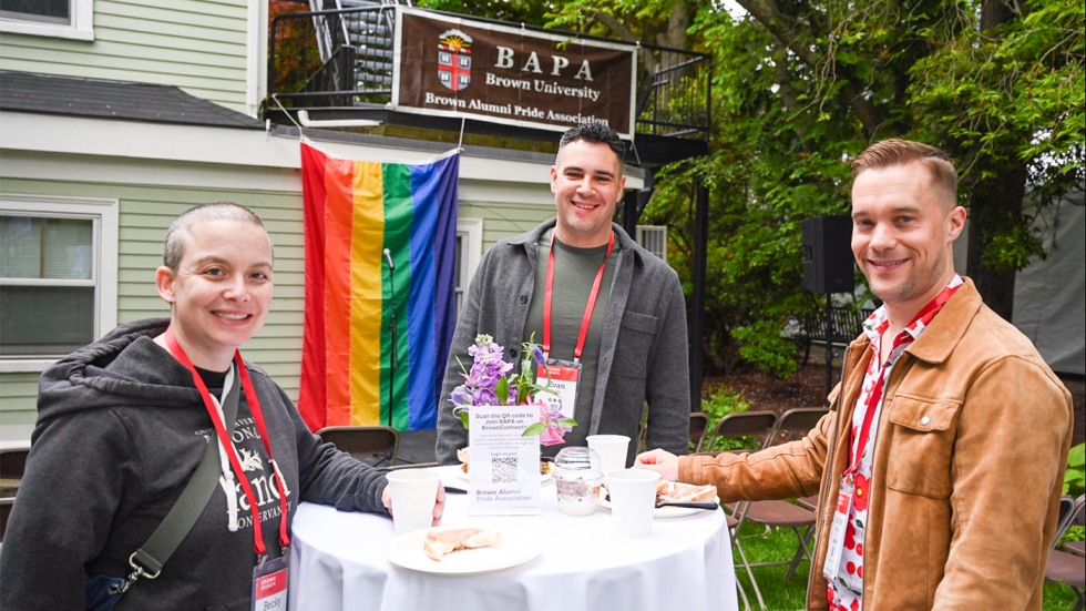 Three alums gathered around a hightop table outside of Stonewall House during the BAPA Celebration.