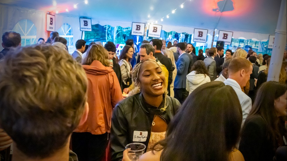 Current and former student-athletes gathered under a tent at the Brown Bear Social.