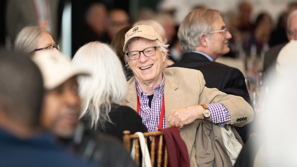 seated alum laughing in conversation