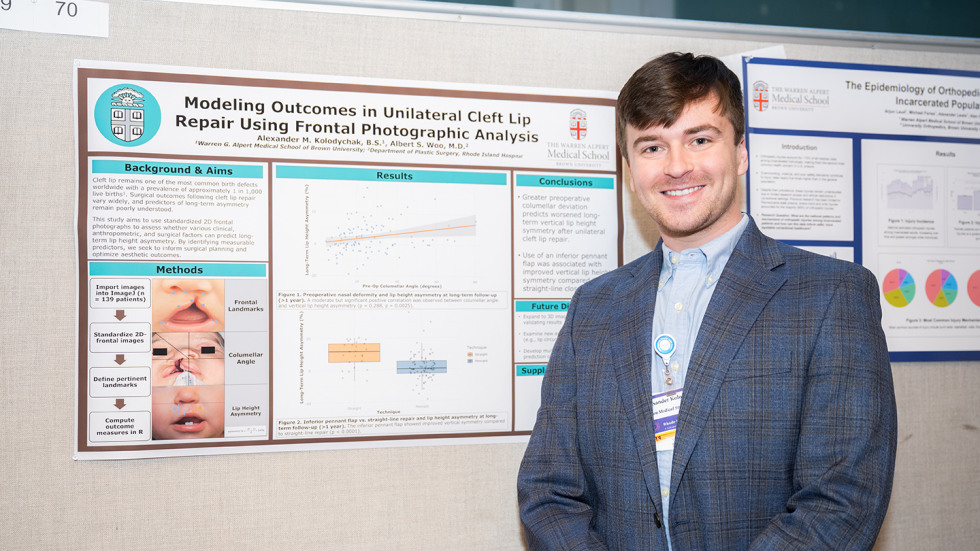Alex Kolodychak MD’28 with his poster detailing his research in unilateral cleft lip repair. 